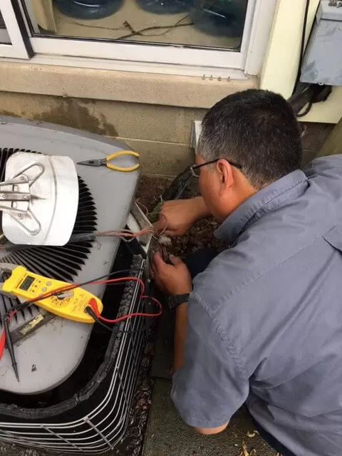 Ac Maintenance Technician Fixing Ac Unit