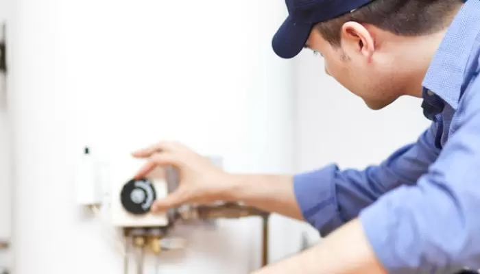 Technician Adjusting Water Heater 5