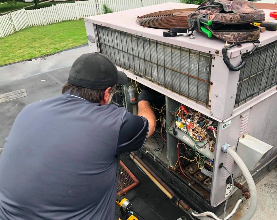 Technician Working On Air Conditioning Unit