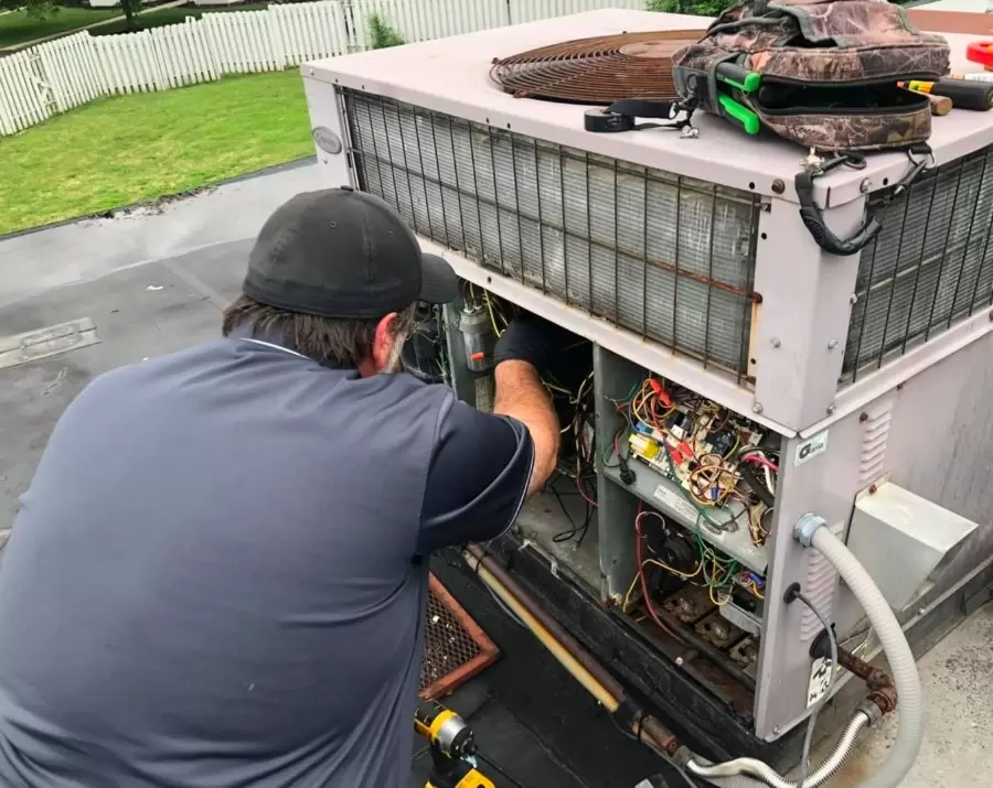 Technician Working On Air Conditioning Unit